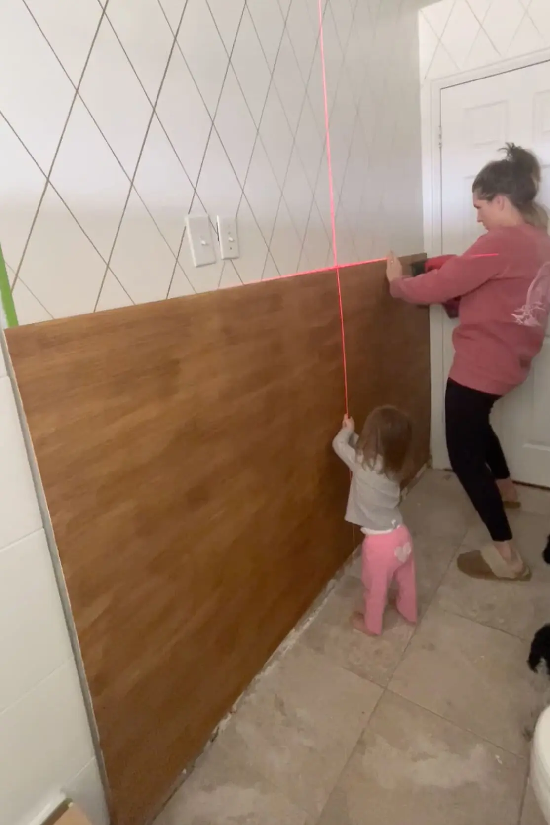 Adding board and batten to a bathroom wall.